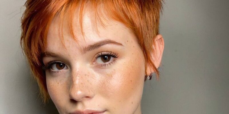 Vibrant copper pixie, natural freckles embraced, professional studio glow—portfolio work that launches beauty careers. See how confident styling choices create magnetic creator content.